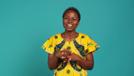 Cheerful-feminine-girl-having-a-laugh-posing-against-blue-background