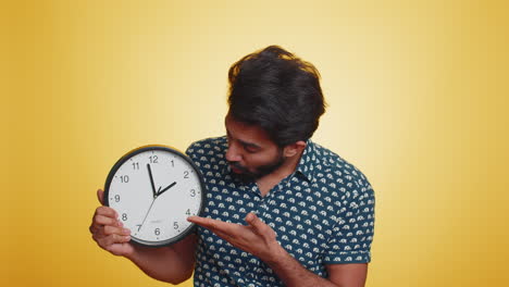 Young-indian-man-with-anxiety-checking-time-on-clock,-running-late-to-work,-being-in-delay,-deadline