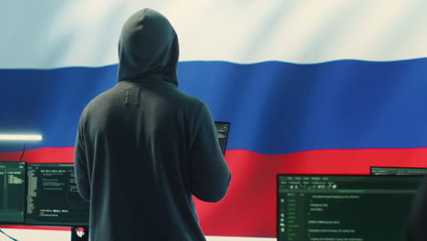 Propagandist-person-in-a-Russian-cybersecurity-center-with-the-national-flag