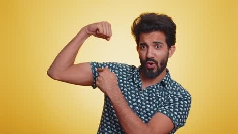 Fit-sporty-indian-man-showing-biceps-and-looking-confident,-feeling-power-strength-success-win