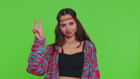 Young-hippie-woman-showing-victory-sign-hoping-for-success-and-win-doing-peace-gesture-smiling