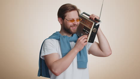 Happy-man-using-retro-tape-record-player-to-listen-music-disco-dancing-of-favorite-track-having-fun