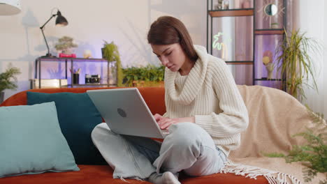 Amazed-young-woman-use-laptop-computer,-receive-good-news-message,-shocked-by-victory,-celebrate-win