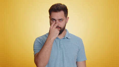 Young-man-pointing-at-his-eyes-and-camera-show-I-am-watching-you-gesture-spying-watching-on-someone