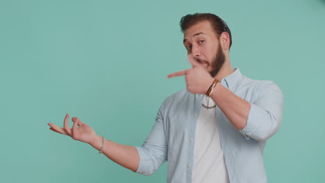 Lebanese-man-showing-thumbs-up-pointing-empty-place-advertising-area-for-commercial-text,-copy-space