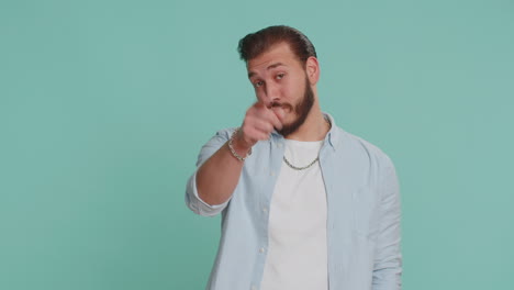 Lebanese-man-looking-at-camera-doing-phone-gesture-like-says-hey-you-call-me-back-conversation