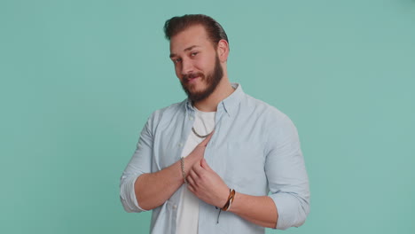 Smiling-arabian-man-makes-heart-gesture-demonstrates-love-sign-expresses-good-feelings-and-sympathy