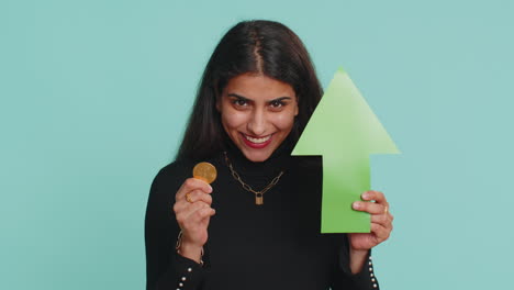 Indian-woman-winner-holding-arrow-sign-pointing-up-showing-golden-bitcoins-cryptocurrency-mining-BTC