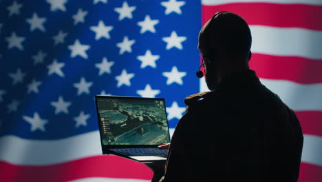 US-Air-Force-dispatcher-looking-at-surveillance-transmission,-United-States-flag