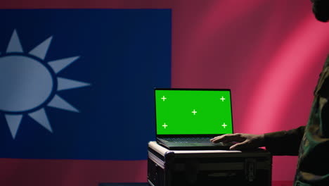 Taiwanese-insurgent-using-military-tech-on-green-screen-laptop