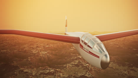 An-aerial-view-of-the-white-sailplane-with-no-propeller-calmly-gliding-in-the-sky,-over-snow-covered-mountains.-Flying-aerodynamic-aircraft-is-a-great-way-of-spend-leisure-time.