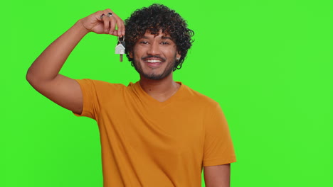 Young-indian-man-real-estate-agent-showing-keys-of-new-home-house-apartment,-buying-renting-property