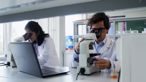 Scientists-with-Microscopes-Working-in-Laboratory.science-research,-work-and-people-concept-international-female-scientists-with-microscopes-working-in-laboratory