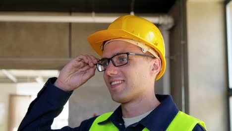 Builder-in-Helmet-with-Clipboard-Walking-Upstairs.architecture,-construction-and-building-concept-male-builder-in-helmet-and-safety-west-with-clipboard-walking-upstairs