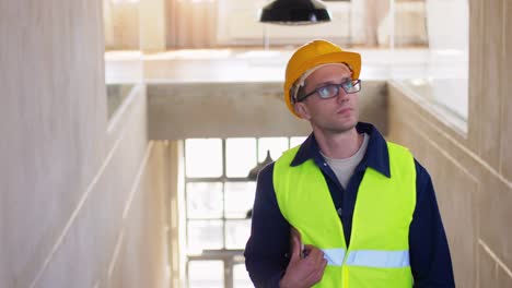 Builder-in-Helmet-with-Clipboard-Walking-Upstairs.architecture,-construction-and-building-concept-male-builder-in-helmet-and-safety-west-with-clipboard-walking-upstairs