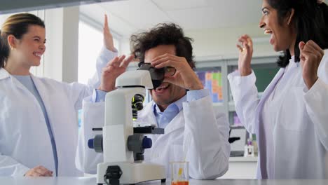 Scientists-with-Microscopes-Working-in-Laboratory.science-research,-work-and-people-concept-international-female-scientists-with-microscopes-working-in-laboratory