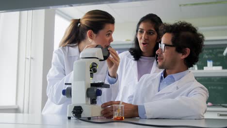 Scientists-with-Microscopes-Working-in-Laboratory.science-research,-work-and-people-concept-international-female-scientists-with-microscopes-working-in-laboratory