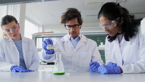 International-Group-of-Scientists-in-Laboratory.science-research,-work-and-people-concept-international-group-of-happy-scientists-with-clipboards-discussing-report-in-laboratory