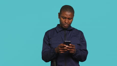 Security-guard-using-smartphone,-taking-break-during-protection-job-shift