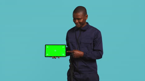 Portrait-of-happy-security-staff-member-showing-isolated-screen-tablet