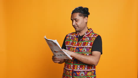 Worker-looking-over-paperwork-graphs,-studio-background