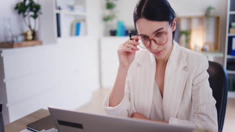 Confident-Female-Boss-Working-on-Laptop-in-Office