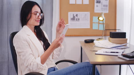 Happy-Businesswoman-Browsing-Smartphone-and-Watching-Social-Media