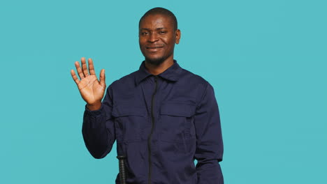 Portrait-of-jolly-bodyguard-waving-hand-towards-visitors