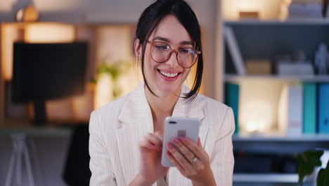 Happy-Businesswoman-Browsing-Internet-on-Smartphone