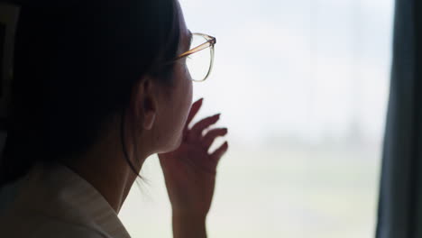 Pensive-Woman-Looks-Out-the-Window-for-Inspiration