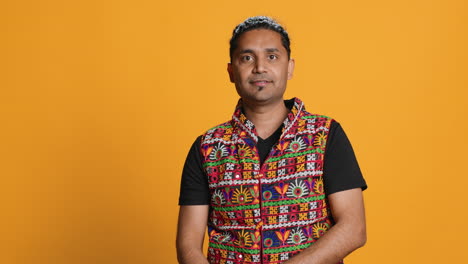 Portrait-of-joyful-man-celebrating,-studio-background