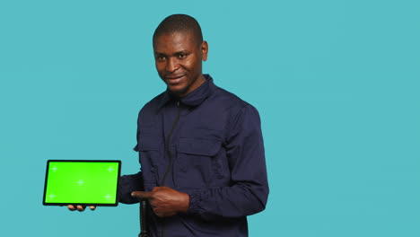 Portrait-of-happy-security-staff-member-showing-isolated-screen-tablet