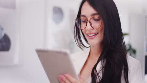 Happy-Businesswoman-Browsing-Internet-on-Digital-Tablet