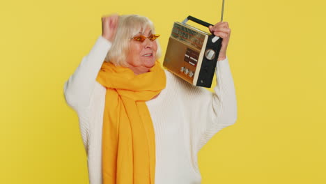 Happy-old-woman-listen-music-on-retro-tape-record-player,-disco-dancing,-fan-of-vintage-technologies