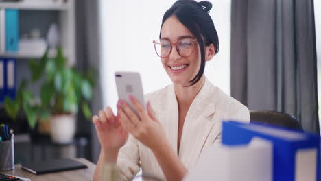 Enterprising-Businesswoman-Browsing-Social-Media-in-Office