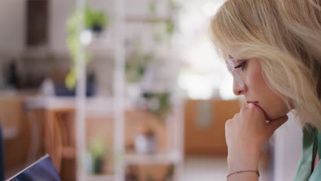 Concentrated-Woman-Using-Laptop-in-Office