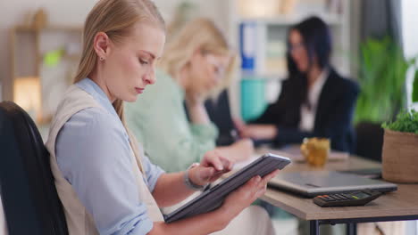 Businesswoman-Using-Tablet-in-Corporate-Office