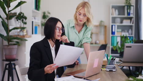 Two-Businesswomen-Discuss-New-Project-Over-Laptop