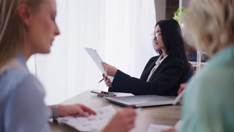 Confident-Female-Boss-Looking-Through-Documents