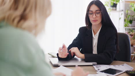 Confident-Businesswoman-Conducts-Meeting-and-Presents-Services