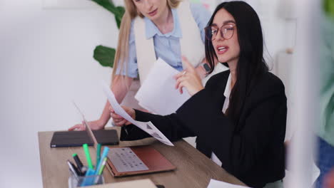 Female-Corporate-Employees-Analyzing-Documents-and-Brainstorming