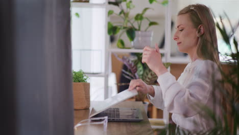 Positive-Smiling-Woman-Finishes-Work-on-Laptop