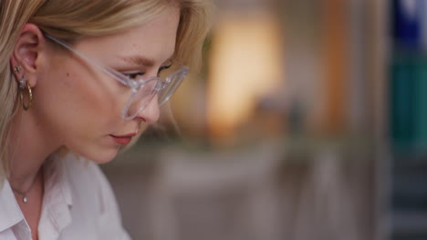 Close-Up-of-Woman's-Face-Working-on-Laptop-in-Evening