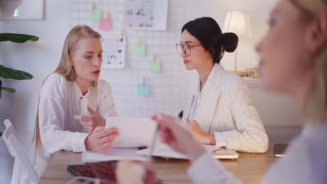 Two-Women-Discuss-Business-Topics-During-Meeting