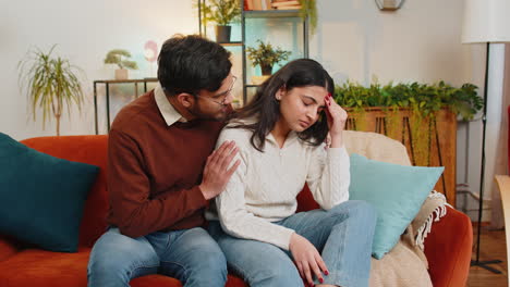 Caring-man-comforting-upset-Indian-girlfriend-supporting-depressed-woman-because-of-bad-day-at-home