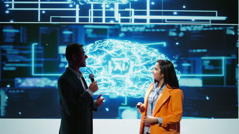 Presenter-and-guest-chatting-during-AI-summit-discussion-panel