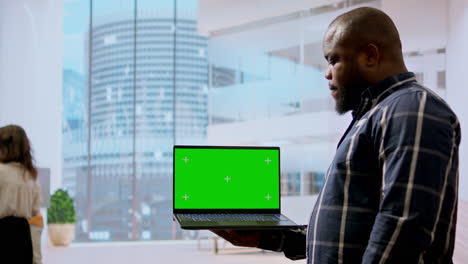 Realtors-and-client-evaluating-blueprints-next-to-green-screen-display