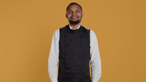 Skilled-waiter-showing-a-thumbs-up-symbol-in-front-of-the-camera