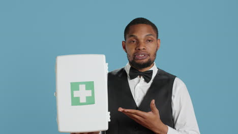 Hotel-porter-employee-presenting-a-first-aid-kit-used-for-medical-emergencies