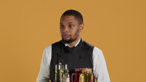 Waiter-bringing-drinks-in-glasses-on-a-tray-for-clients-at-a-table,